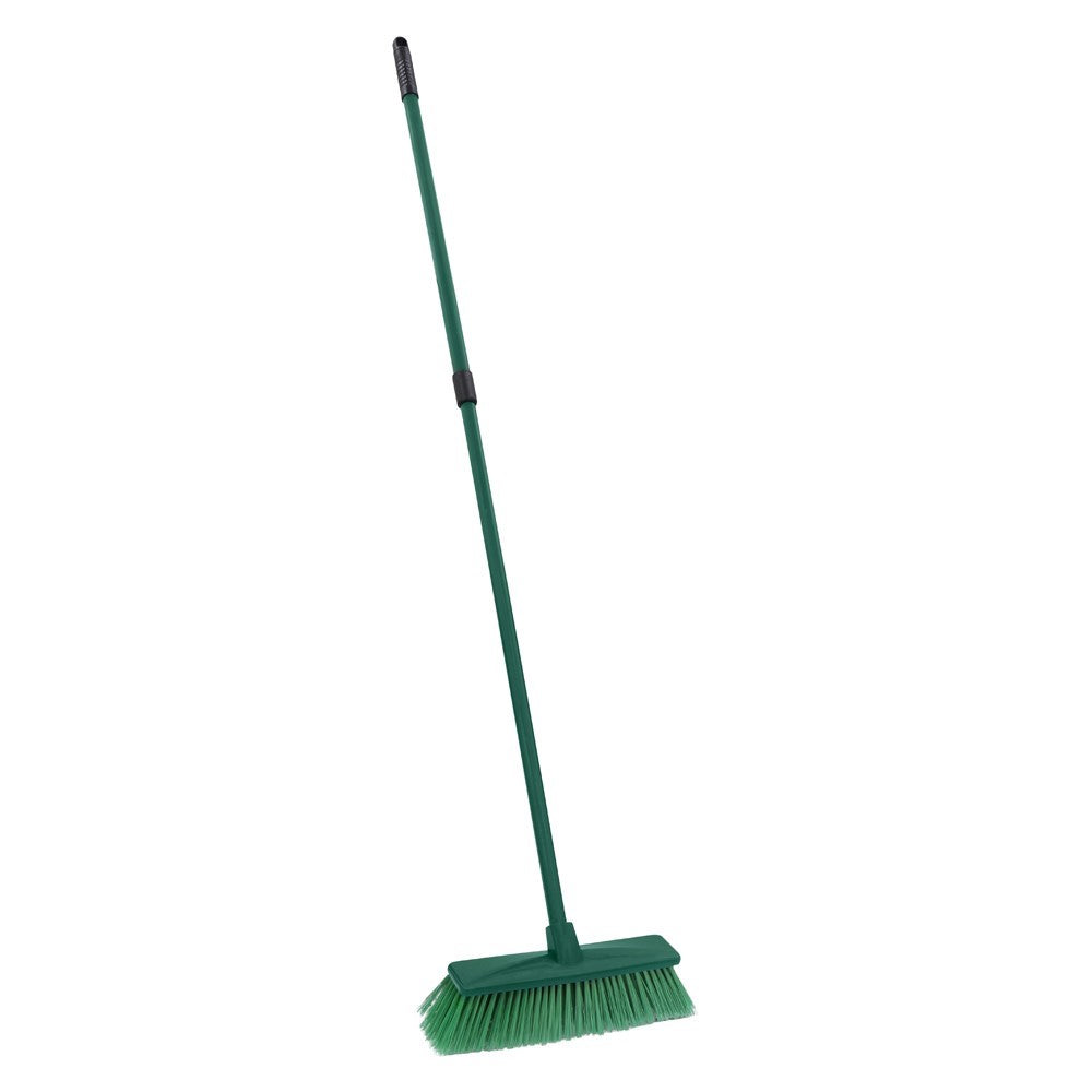 The Gardener hard bristle broom with green extendable handle and angled bristles on white background