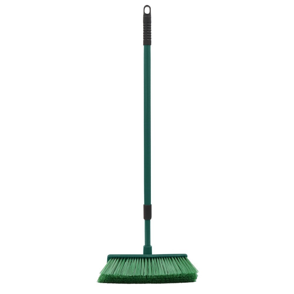 The Gardener hard bristle broom with green extendable handle and angled bristles on white background