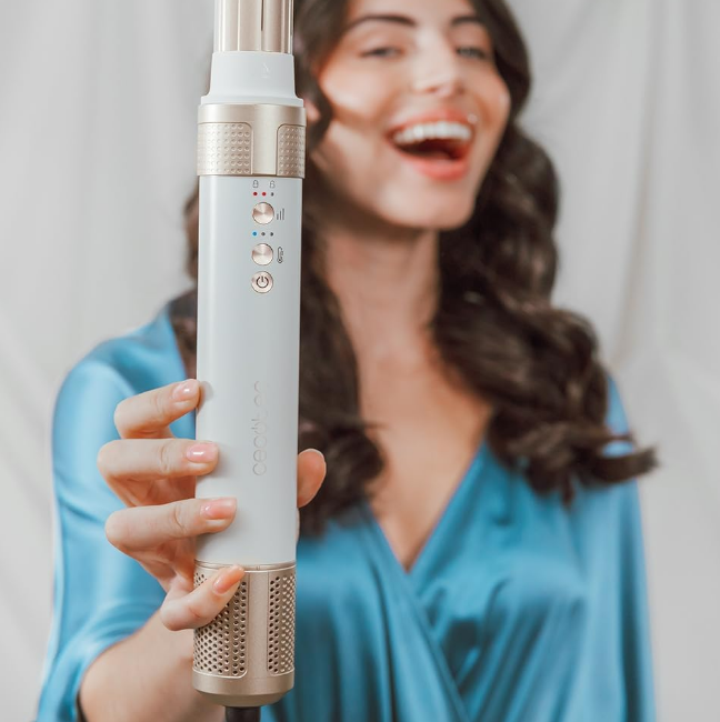 Cecotec Bamba 14in1 AirGlam Styler held close, showing control buttons and gold accents.