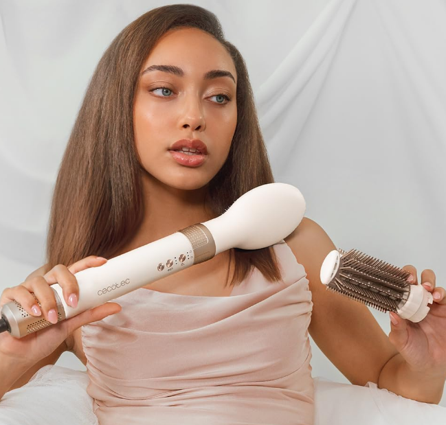 Woman holding Cecotec Bamba 14in1 AirGlam Styler with detachable round brush attachment