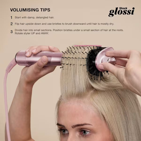 Shark Glossi 2-in-1 Hot Tool and Air Glosser in lychee pink being used to style blonde hair with a round brush attachment.