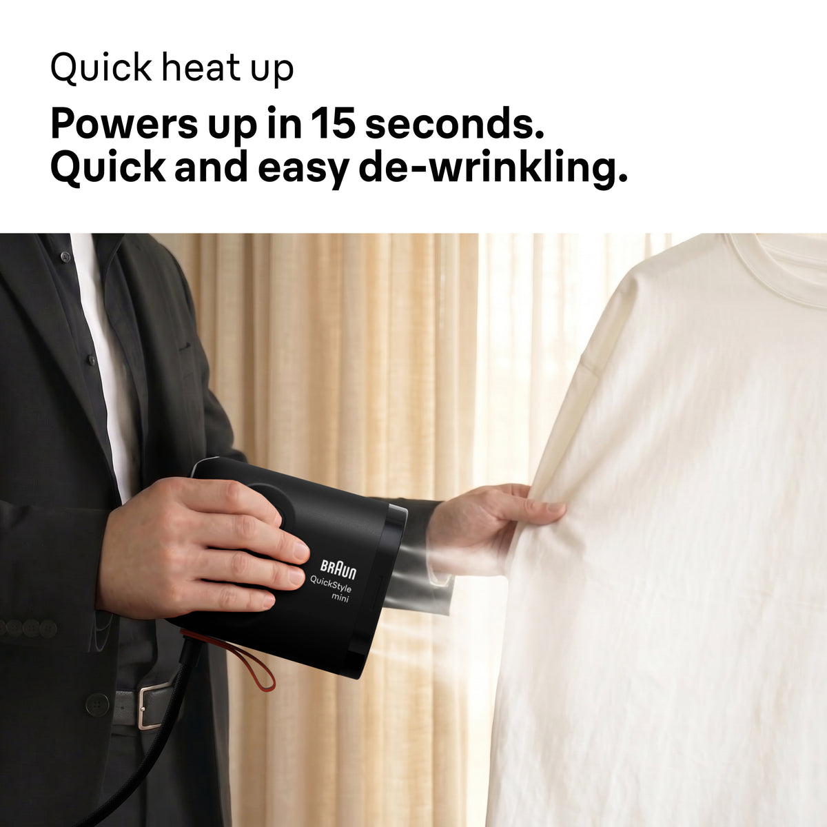 Person using Braun Carestyle Mini Travel Garment Steamer on a white shirt in front of beige curtains