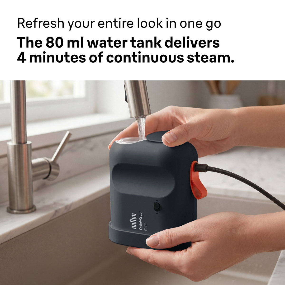 Hands filling the Braun Carestyle Mini Travel Garment Steamer water tank under a kitchen faucet