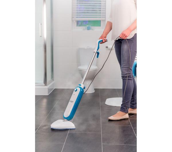 Person using Russell Hobbs Steam and Clean Steam Mop RHSM1001G on dark tiled bathroom floor with steam visible