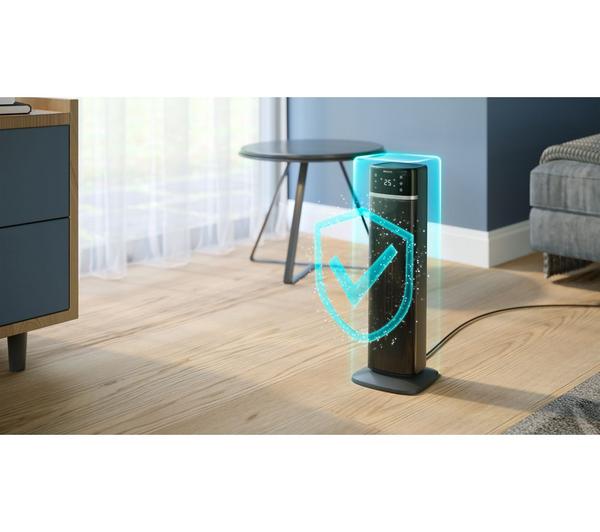 Philips Smart Tower Heater 5000 Series in dark grey standing on wooden floor near table and sofa with digital display on top