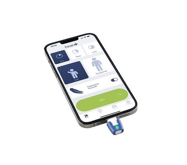 Heat-It Classic USB C insect bite healer plugged into a smartphone with app interface visible.