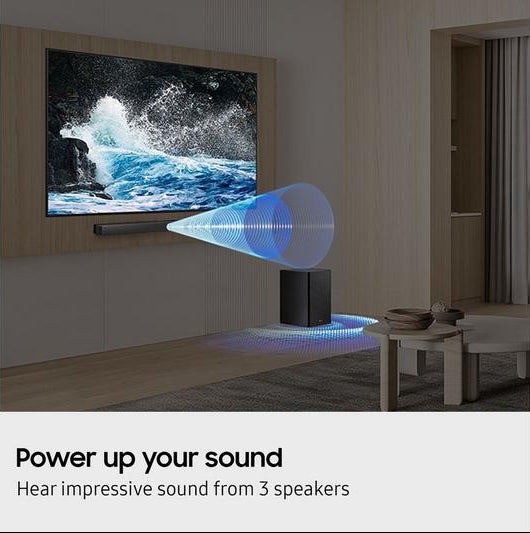 Samsung HW-B450F/XU soundbar mounted below TV with wireless subwoofer on floor in living room.