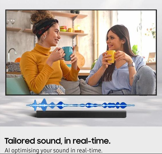 Samsung HW-B450F/XU 2.1 wireless sound bar below a TV showing two women chatting and holding mugs.