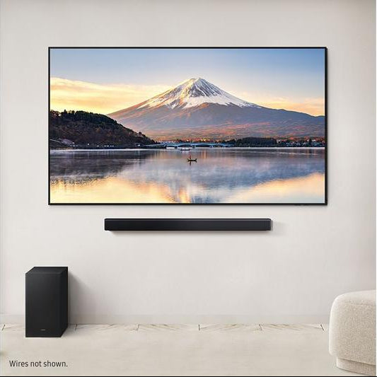 Samsung HW-B450F/XU 2.1 wireless soundbar and subwoofer below a wall-mounted TV showing a mountain scene