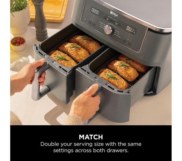Ninja MAX 6-in-1 Dual Zone Air Fryer with two open drawers cooking salmon fillets, showing dual zone feature.