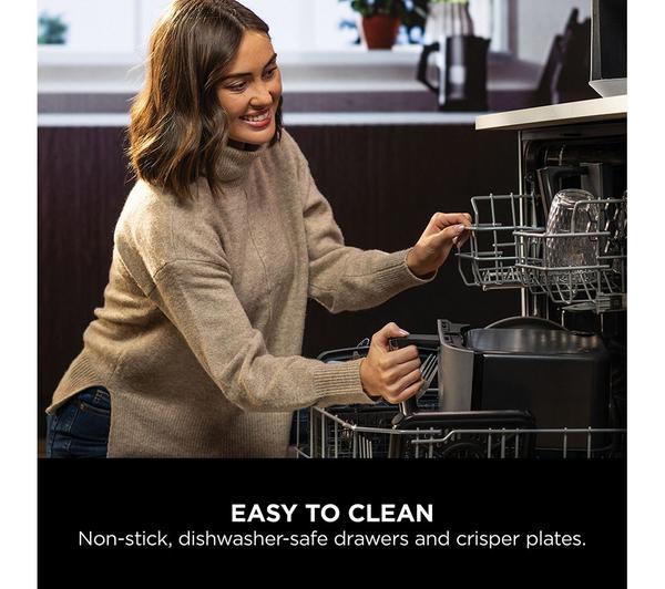 Woman placing the dark grey Ninja MAX 6-in-1 Dual Zone Air Fryer drawer into a dishwasher.