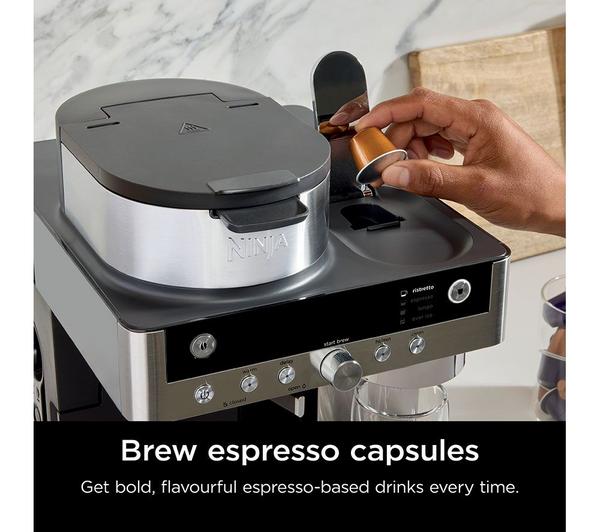 Ninja Prestige DualBrew System with hand inserting an espresso capsule into the machine's top slot