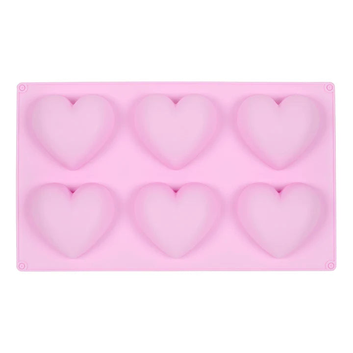Pink silicone mould with six heart-shaped cavities for baking or crafting.