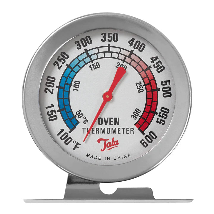 Tala Oven Thermometer with stainless steel frame, temperature dial in °F and °C, and red needle on stand.