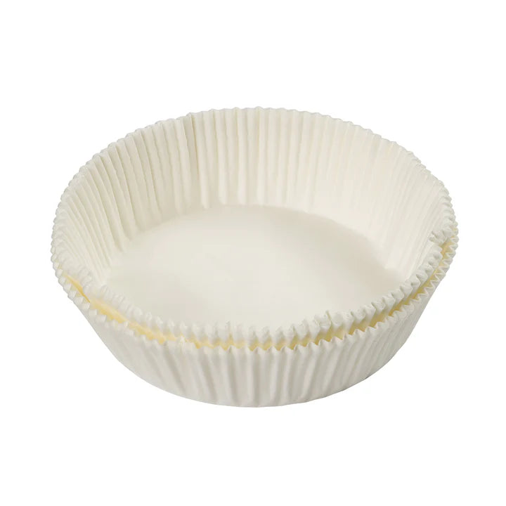 Stack of white Tala 50 siliconised 18cm cake tin liners with fluted edges on white background