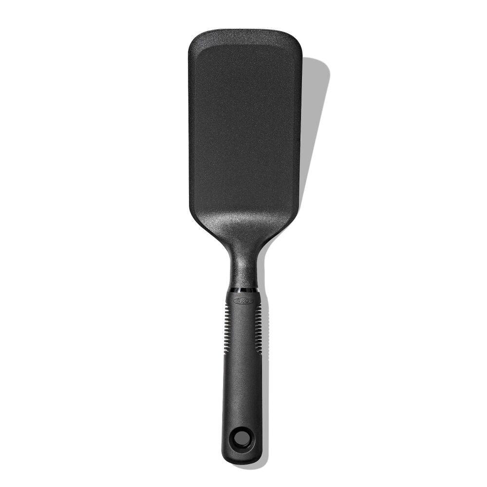 Oxo Good Grips black nylon lasagne turner with broad head and soft, non-slip handle on white background