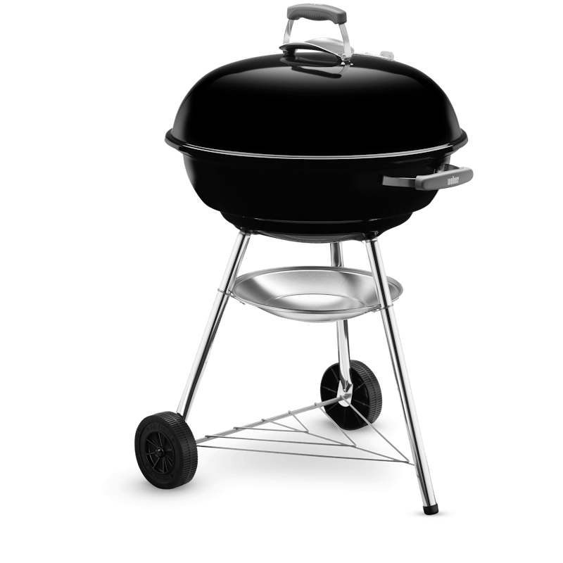 Weber Compact Kettle charcoal barbecue with black lid, silver legs, two wheels, and ash catcher tray below grill bowl
