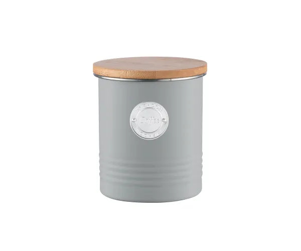 Grey cylindrical coffee storage container with wooden lid and metal coffee label on front