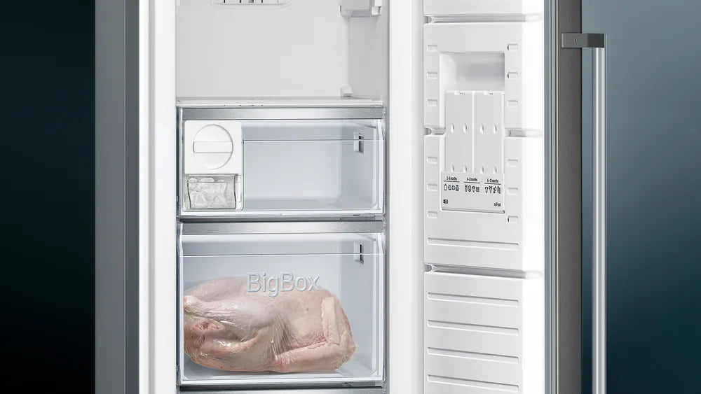 Siemens IQ500 freezer interior showing two transparent drawers, one labeled BigBox with frozen chicken inside.