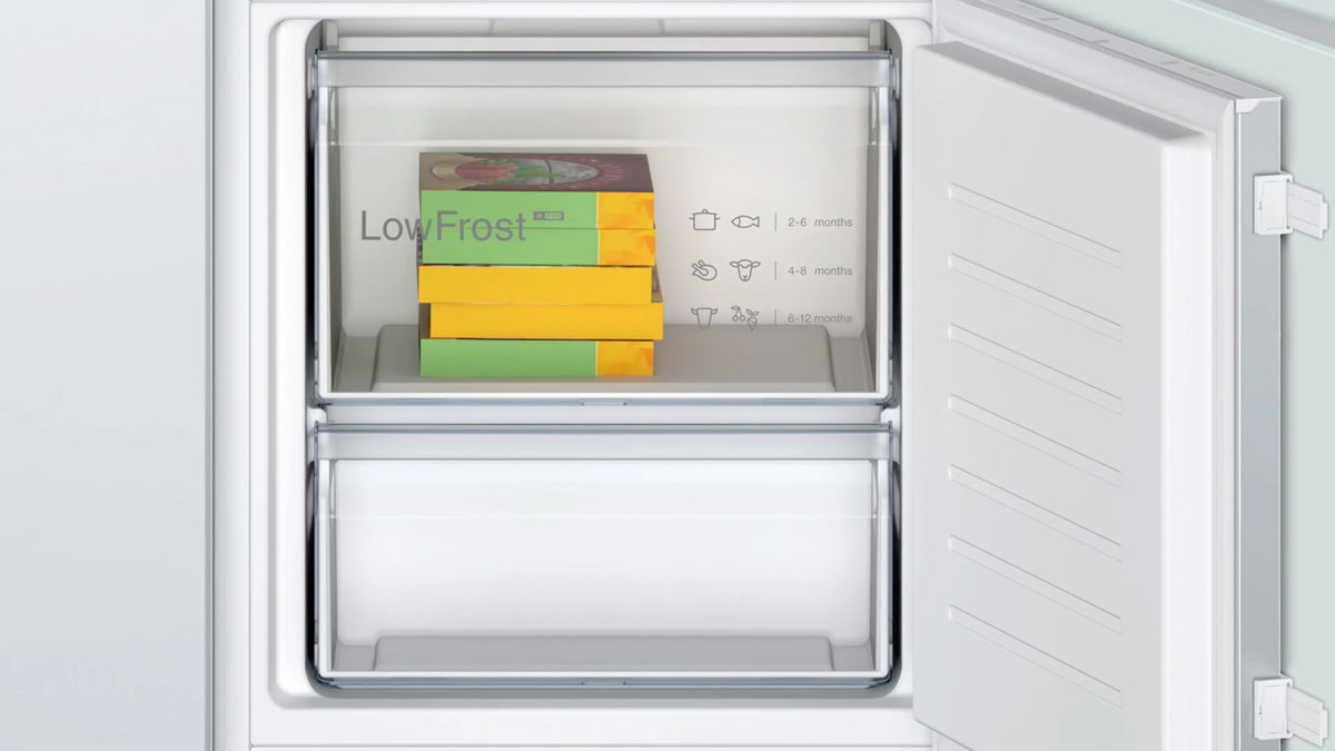 Open freezer compartment of Bosch Series 2 fridge freezer showing stacked frozen food boxes and storage guidelines.