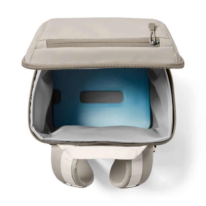 Open Yeti Eu Daytrip 20L Backpack in Cape Taupe showing insulated interior with blue ice pack inside