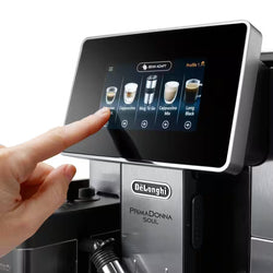 Person interacting with a De'Longhi PrimaDonna Soul coffee machine's touch screen.