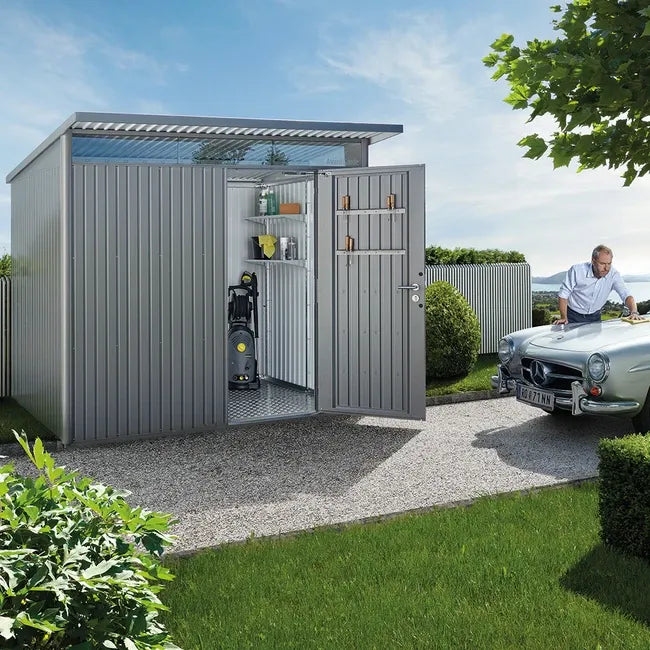 Biohort Avantgarde Shed in quartz grey with open standard door showing interior shelves and garden tools.