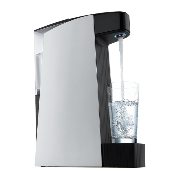 Carbon8 One Touch Sparkling Water Dispenser pouring sparkling water into a clear glass from a side angle.