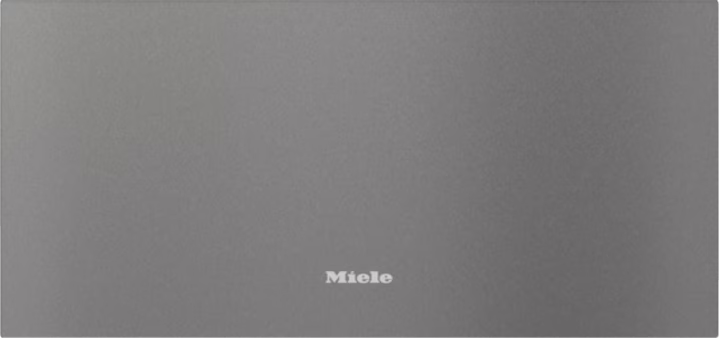 Closed graphite grey Miele ESW 7020 29cm Sous Chef warming drawer with centered logo on front panel.