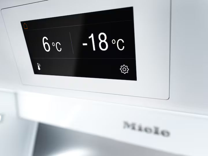Close-up of Miele K 2902 Vi fridge digital display showing temperatures 6°C and -18°C.
