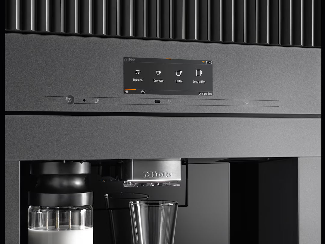 Close-up of Miele Built-In Coffee Machine CVA 7845 touchscreen with drink options and milk container.