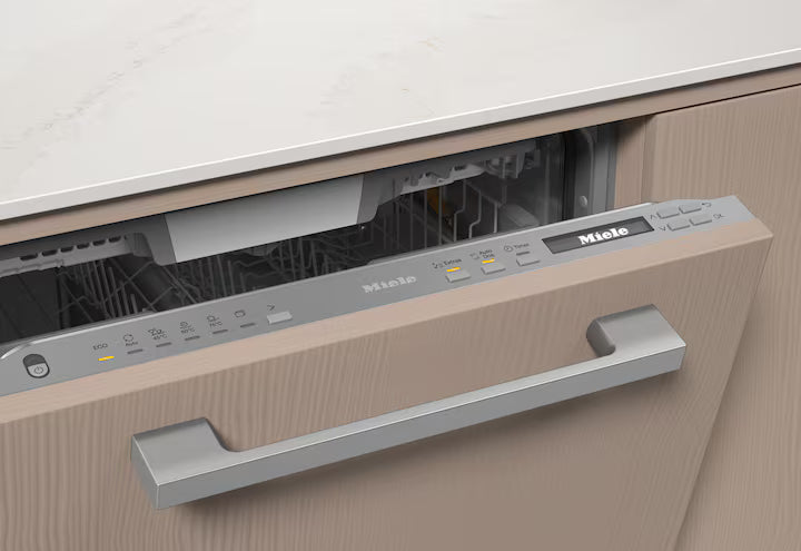 Partially open Miele G 7080 SCVi dishwasher integrated into wood cabinetry with control panel and handle visible.