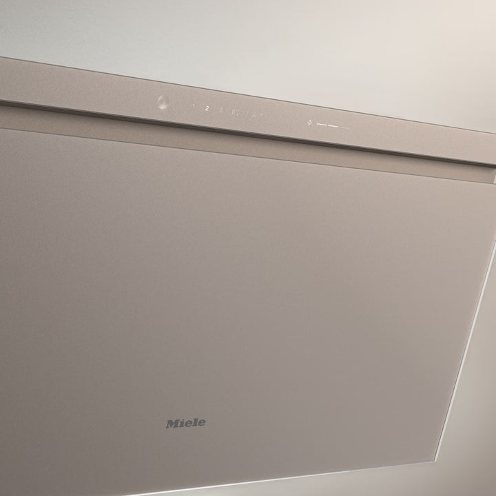 Close-up of the pearl beige Miele DAH 4980 Sienna 90cm wall-mounted hood with control panel and logo visible.