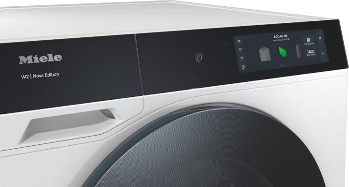 Close-up of the Miele WQ 1000 WPS washer control panel with digital display and door handle.