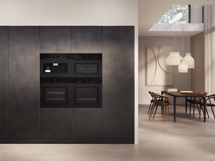 Miele Built-In Coffee Machine in obsidian black matt integrated into a modern kitchen wall unit.