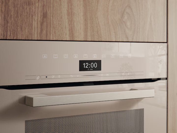 Close-up of Miele H 7464 BP VitroLine oven control panel in pearl beige with digital clock display.