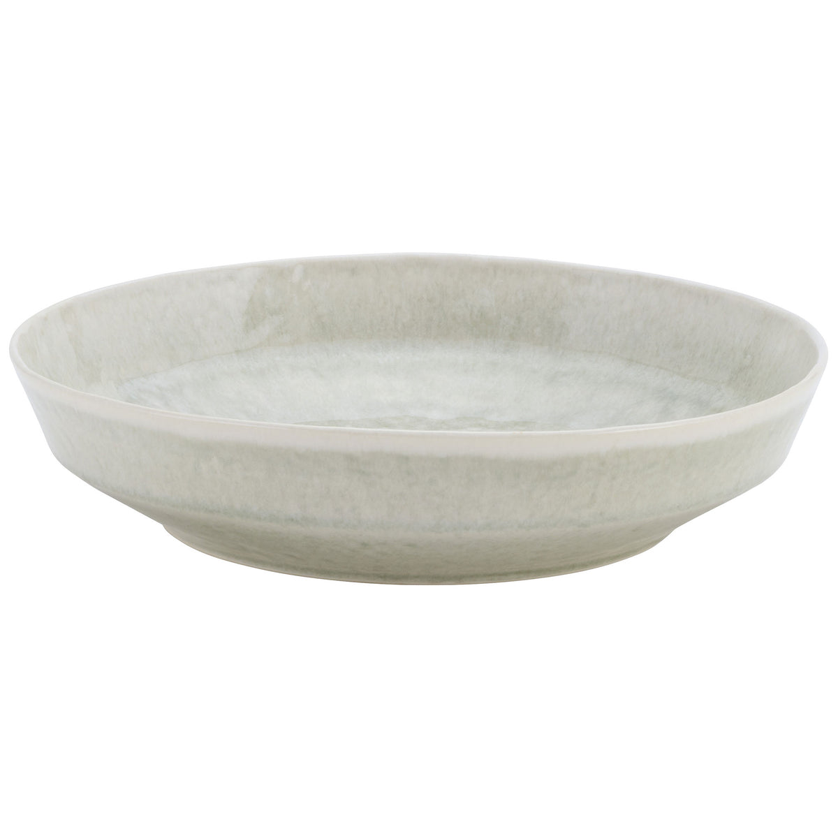 Close-up of a pale green Stellar Stoneware Bantham pasta bowl showing its textured glaze and shallow depth.