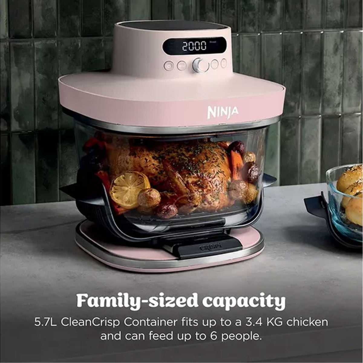 Ninja Crispi Pro 7-in-1 glass air fryer in rose quartz with cooked chicken and vegetables inside