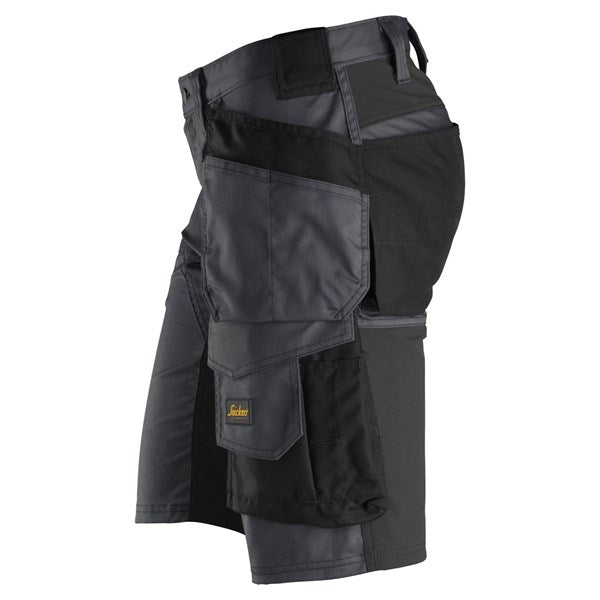 Snickers Stretch Shorts in black and grey, shown from the side with multiple pockets and reinforced areas.