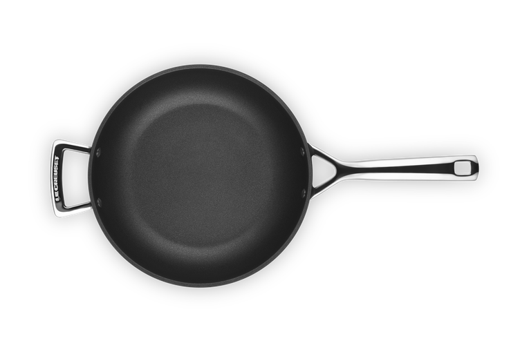 Le Creuset Toughened Non-Stick Deep Frying Pan 26cm with black interior and metal handles, top view.