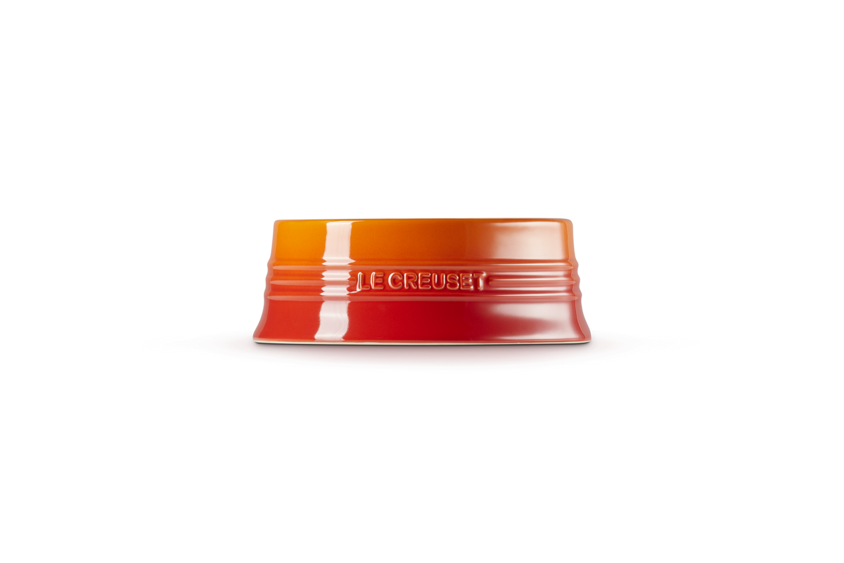 Le Creuset medium pet bowl in volcanic color, shown upside down with logo embossed on side.