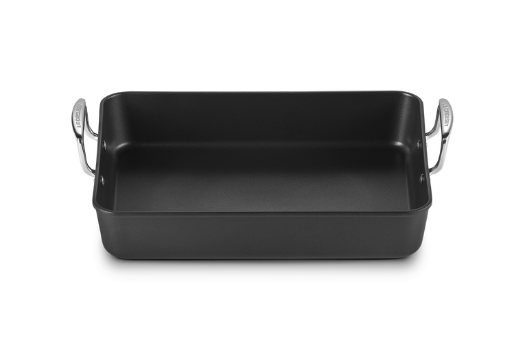 Le Creuset Toughened Non Stick Rectangular Roaster 35cm with black interior and silver handles shown from above.