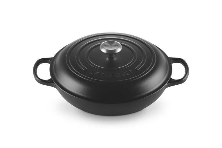 Le Creuset Signature cast iron shallow casserole in satin black with lid and side handles, front angle view.
