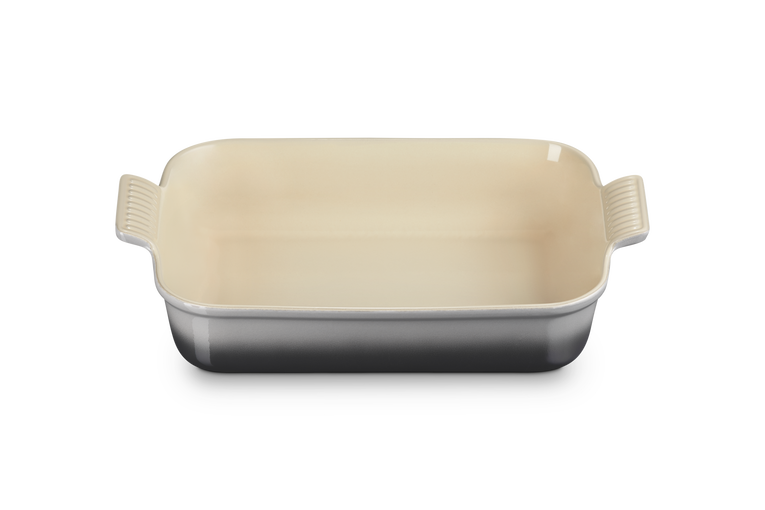 Le Creuset rectangular stoneware dish in flint with cream interior, shown from above angle.