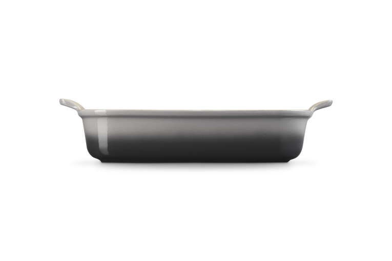 Le Creuset Stoneware Heritage rectangular dish in flint, side view showing handles and smooth finish.