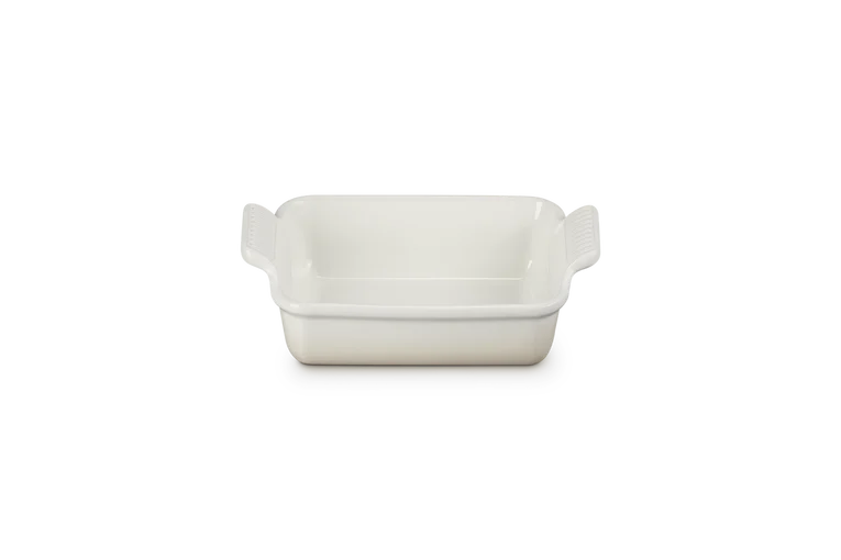Le Creuset rectangular stoneware dish in meringue color, front view showing handles and smooth interior.