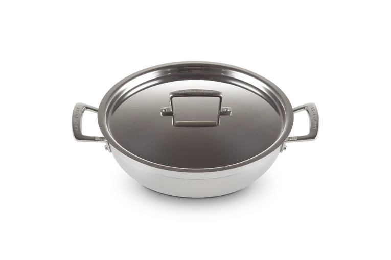 Le Creuset Classic 3-ply stainless steel shallow casserole with lid, shown from the top angle.