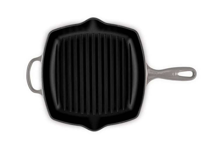 Le Creuset 26cm square grill pan in flint with ridged cooking surface and two handles, top view.