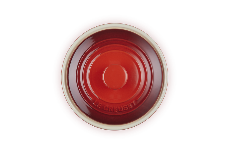 Le Creuset Stoneware Camembert Baker in cerise, top view showing lid with embossed logo.