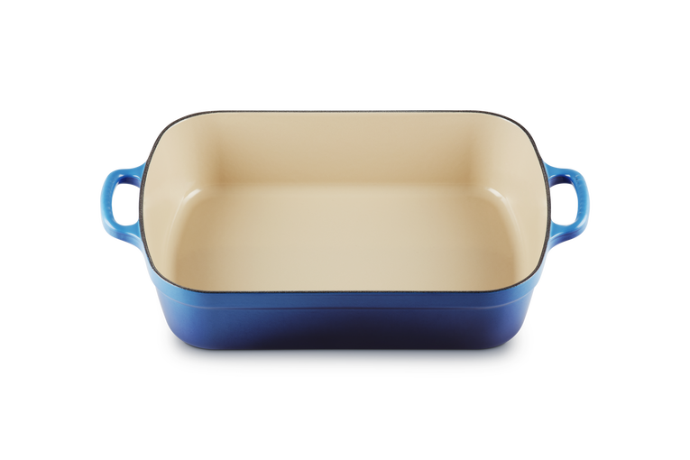 Le Creuset 33cm cast iron rectangular roaster in azure with cream interior, shown from above.